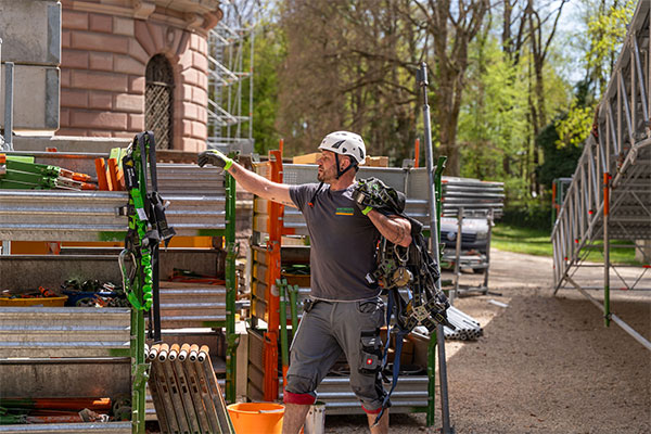 Ein Gerüstbauer legt Sicherheitsequipment an